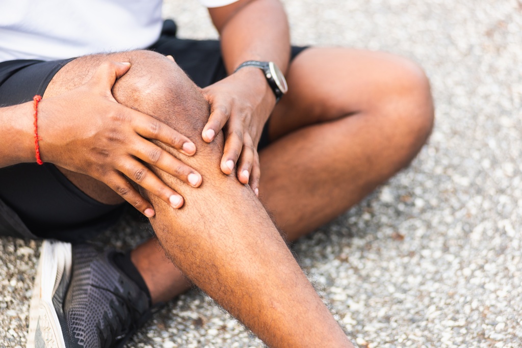Low Section Of People Sitting On Beach